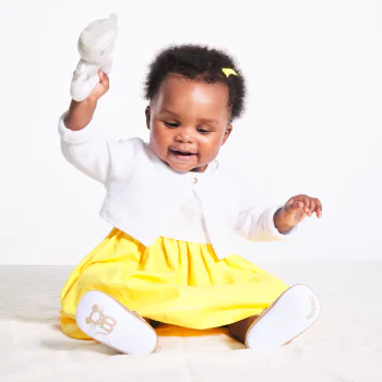 Baby girl's short white knitted bolero cardigan