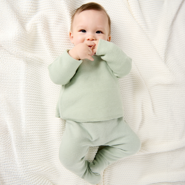 Newborn's wrap-around green knitted jumper